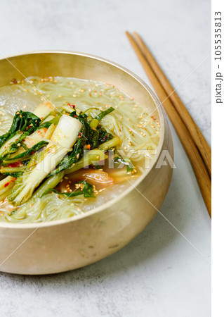 Yeolmunaengmyeon, korean style Buckwheat Noodles with YoungSummer Radish Kimchi, This dish features cold noodles in kimchi soup that is made by mixing salted young radish with chopped onion, chives, p Yeolmunaengmyeon, korean style Buckwheat Noodles with YoungSummer Radish Kimchi, This dish features cold noodles in kimchi soup that is made by mixing salted young radish with chopped onion, chives, p 105535813