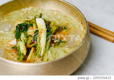 Yeolmunaengmyeon, korean style Buckwheat Noodles with YoungSummer Radish Kimchi, This dish features cold noodles in kimchi soup that is made by mixing salted young radish with chopped onion, chives, p Yeolmunaengmyeon, korean style Buckwheat Noodles with YoungSummer Radish Kimchi, This dish features cold noodles in kimchi soup that is made by mixing salted young radish with chopped onion, chives, p 105535815