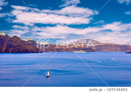Panorama of Santorini, Greece, on sunny day, sailboats and white towns 105536802