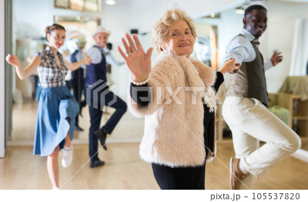 Senior womaSenior woman and man dancing swing in studion and man dancing swing in studio Senior womaSenior woman and man dancing swing in studion and man dancing swing in studio 105537820