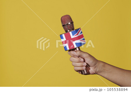 man has a microphone patterned with the flag of UK 105538894