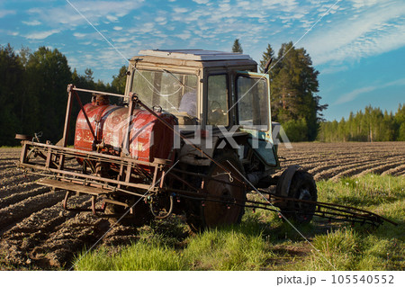 Mounted crop sprayer on boom added to wheeled tractor. Mounted crop sprayer on boom added to wheeled tractor. 105540552