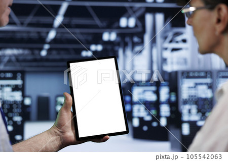 Computer scientists using mock up tablet to check blade servers, close up. Machines in computer network security data storage business providing processing and memory resources for several workloads 105542063