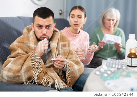Sick man sitting with wife and mother Sick man sitting with wife and mother 105542244