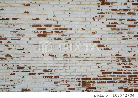 old white paint on red brick wall use as grounge background old white paint on red brick wall use as grounge background 105542704