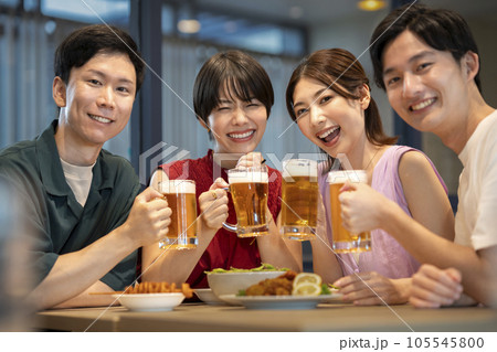 ビールで乾杯する笑顔の若い男女　カメラ目線　ポートレート 105545800