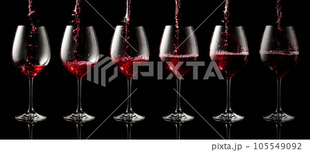 Pouring red wine into a glass. 105549092