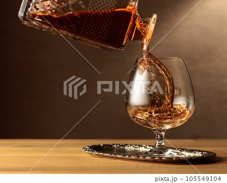 Brandy is poured into a snifter glass. 105549104