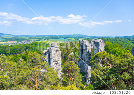 Panoramic view of a sandstone rock city in Bohemian Paradise, Czech: Cesky raj. Rock climbers on top of a rocky tower. Czech Republic 105551220