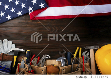 Tools hardhat toolbelt and us flag on wooden background labor day banner mockup Tools hardhat toolbelt and us flag on wooden background labor day banner mockup 105554675