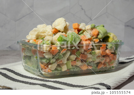 Frozen mixed vegetables for long-term storage. Deep freezing of vegetables. defrosting Frozen food background Frozen mixed vegetables for long-term storage. Deep freezing of vegetables. defrosting Frozen food background 105555574
