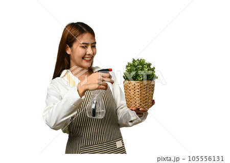 Beautiful Asian female florist wearing apron holding plant isolated on white background 105556131