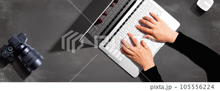 Laptop computer with a SLR camera Laptop computer with a SLR camera 105556224