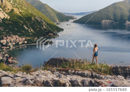 Woman Traveler among Ruins of Ancient Fortress Woman Traveler among Ruins of Ancient Fortress 105557680