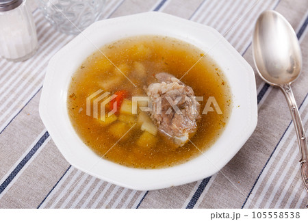 Homemade soup with pork meat on bone and vegetables Homemade soup with pork meat on bone and vegetables 105558538