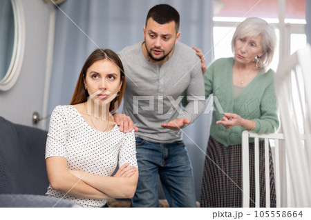 Domestic quarrel - husband and mother try to calm crying wife Domestic quarrel - husband and mother try to calm crying wife 105558664