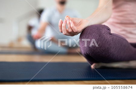 Female hand with fingers folded in mudra lying on knee Female hand with fingers folded in mudra lying on knee 105558674