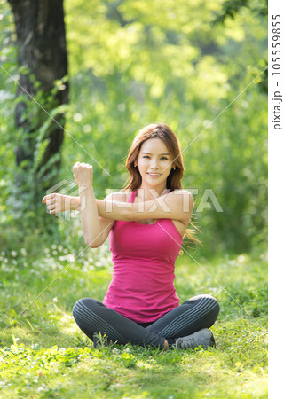 young woman doing yoga in park 105559855
