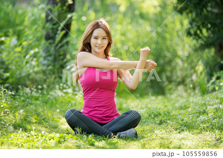 young woman doing yoga in park young woman doing yoga in park 105559856