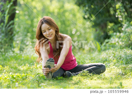 young woman doing yoga in park young woman doing yoga in park 105559946