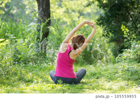 young woman doing yoga in park young woman doing yoga in park 105559955