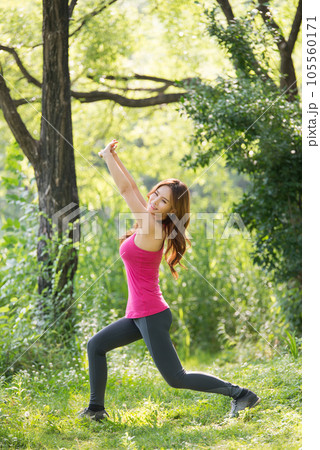 young woman doing yoga in the park 105560171
