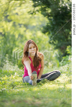 young woman doing yoga in the park 105560186