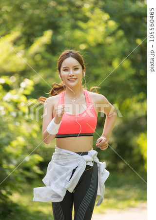 beautiful woman running in the park 105560465