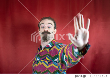 Hipster man with mustache saying No or Stop and looking at camera with open hand Hipster man with mustache saying No or Stop and looking at camera with open hand 105565393