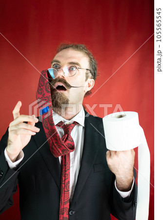 Funny man with glasses, red tie on his head and toilet paper in hand looking up Funny man with glasses, red tie on his head and toilet paper in hand looking up 105565545