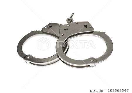Pair of steel handcuffs isolated on white background. Pair of steel handcuffs isolated on white background. 105565547