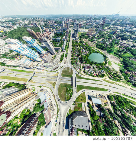 Aerial city view with crossroads and roads, houses, buildings, parks and parking lots. Sunny summer panoramic image Aerial city view with crossroads and roads, houses, buildings, parks and parking lots. Sunny summer panoramic image 105565787