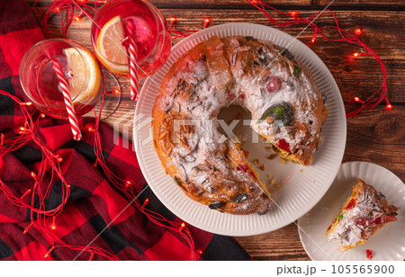 Portuguese Chrismas cake Bolo Rei and drinks on table 105565900