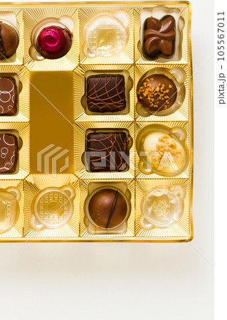 Gourmet chocolates in golden box on a white background. 105567011