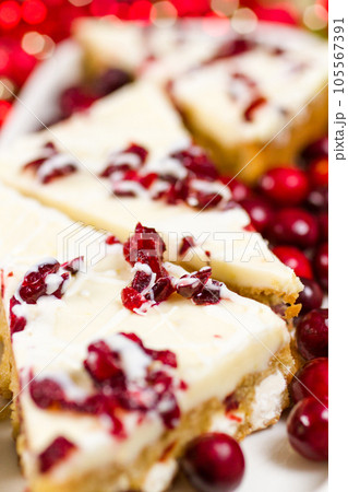 Cranberry bliss bar made with chunks of white chocolate and dried cranberries, topped with sweet cream cheese icing. Cranberry bliss bar made with chunks of white chocolate and dried cranberries, topped with sweet cream cheese icing. 105567391
