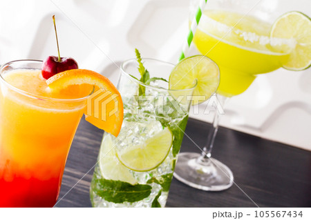 Margarita, mint mojito and tequila sunrise cocktails. Margarita, mint mojito and tequila sunrise cocktails. 105567434