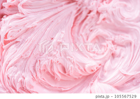 Close up view. Mixing in pink food coloring into a vanilla buttercream frosting for decorating funfettti bundt cake. Close up view. Mixing in pink food coloring into a vanilla buttercream frosting for decorating funfettti bundt cake. 105567529