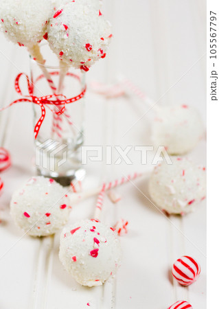 Peppermint chocolate cake pops dipped in white chocolate and candy cane bits. 105567797