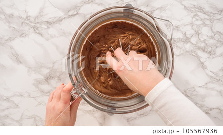 Flat lay. Step by step. Whipping chocolate ganache with an electric kitchen mixer. 105567936