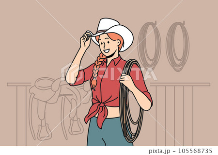 Woman jockey stands in stable wearing cowboy hat and holding long rope waiting for horses to appear. Woman jockey stands in stable wearing cowboy hat and holding long rope waiting for horses to appear. 105568735