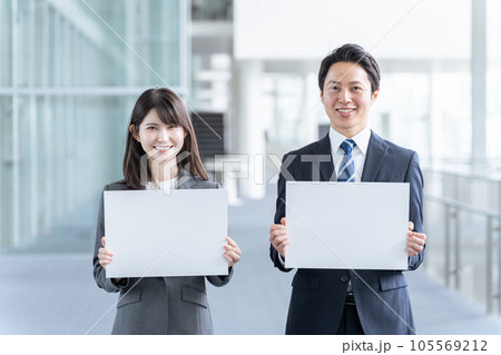 メッセージボードを持つビジネスマン男女 105569212