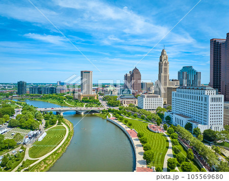 Aerial freshly mowed green park lawns on both sides of Scioto River downtown Columbus Ohio 105569680