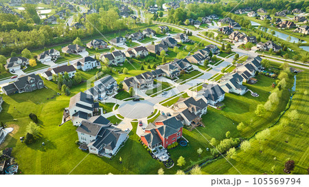 Mini mansion homes in rich neighborhood with lush landscaping in summer Mini mansion homes in rich neighborhood with lush landscaping in summer 105569794