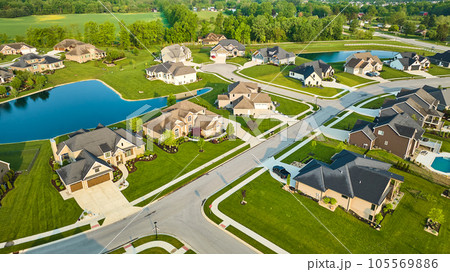 Large expensive multimillion-dollar mini mansions houses in rich neighborhood with pool and ponds 105569886