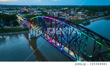 Pride rainbow arch bridge Louisville KY over nighttime Ohio River city lights at night 105569981