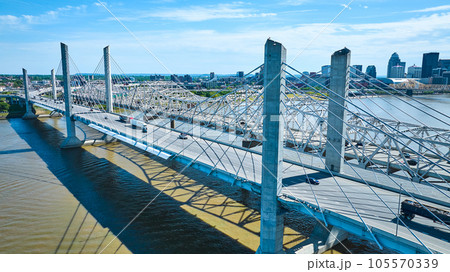 White suspension and truss bridge over Ohio River near downtown Louisville KY aerial 105570339