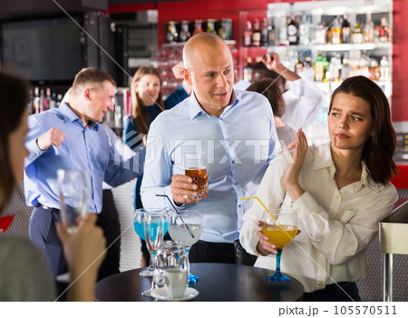 Woman gesturing stop to male Woman gesturing stop to male 105570511