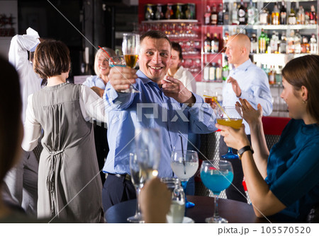 Businessman having fun at corporate party 105570520