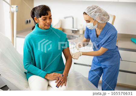 Nurse making injection of covid-19 vaccine 105570631