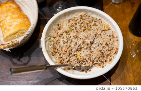 Rice with lentils and onions served on plate 105570863